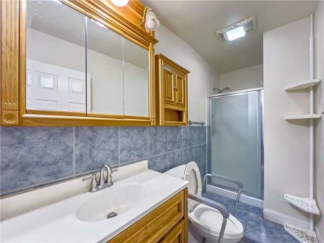 bathroom with tile walls, tile patterned floors, toilet, and vanity