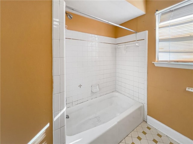 bathroom featuring tile patterned flooring and tiled shower / bath