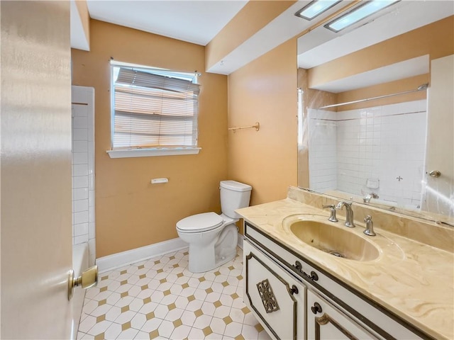 full bathroom with tiled shower / bath combo, tile patterned floors, toilet, and vanity