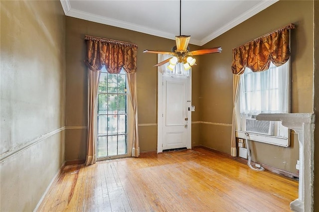 interior space featuring cooling unit, hardwood / wood-style flooring, ceiling fan, and ornamental molding