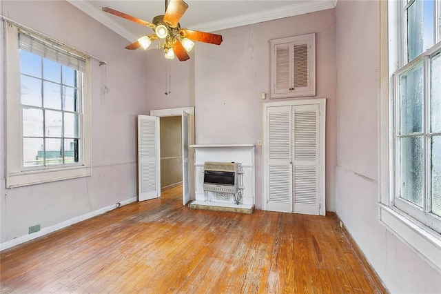 unfurnished living room with ornamental molding, light hardwood / wood-style flooring, and ceiling fan