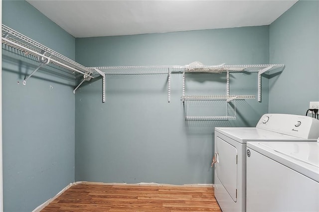 washroom with light hardwood / wood-style floors and independent washer and dryer