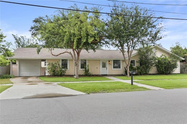 single story home featuring a garage and a front lawn