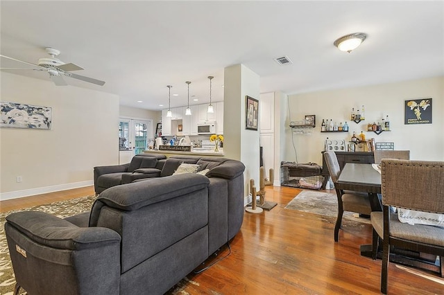 living room with ceiling fan and hardwood / wood-style floors