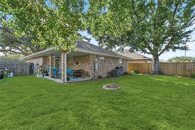 back of house featuring a patio and a lawn