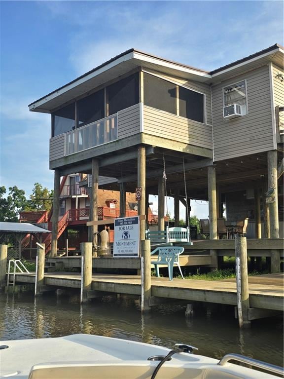 view of dock featuring a water view and cooling unit