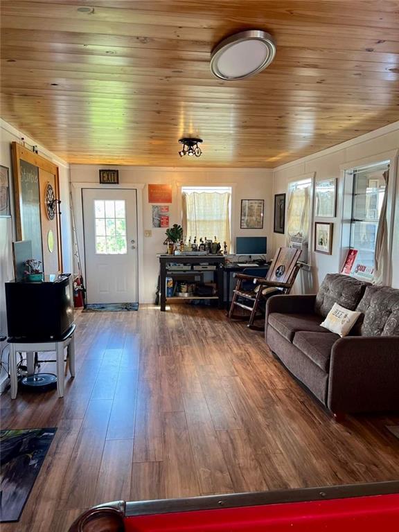 living room featuring hardwood / wood-style floors and wooden ceiling