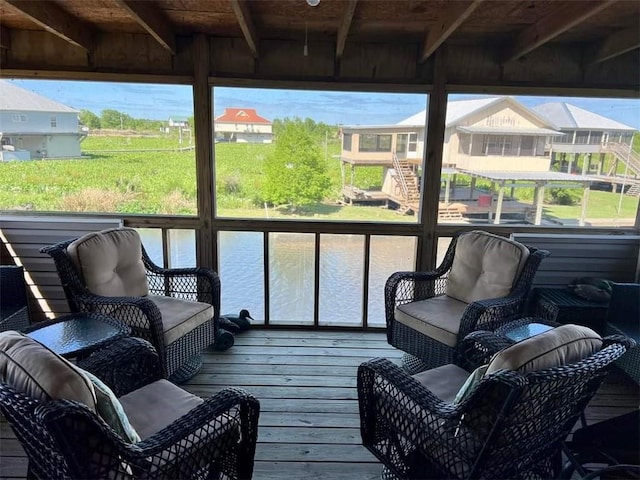 sunroom / solarium featuring a water view and wood ceiling