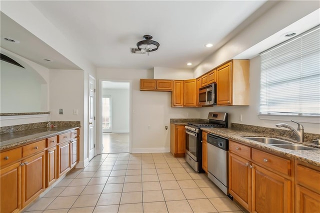 kitchen featuring sink, light tile patterned flooring, plenty of natural light, and stainless steel appliances