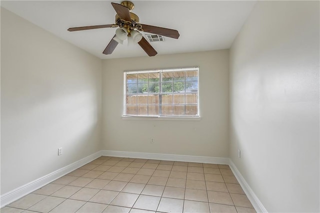 tiled spare room featuring ceiling fan