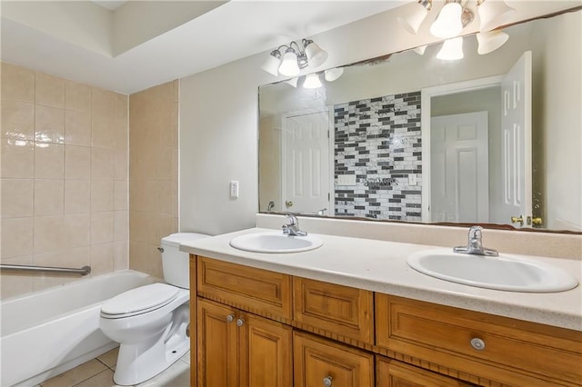 full bathroom featuring tiled shower / bath combo, toilet, tile patterned floors, and double sink vanity