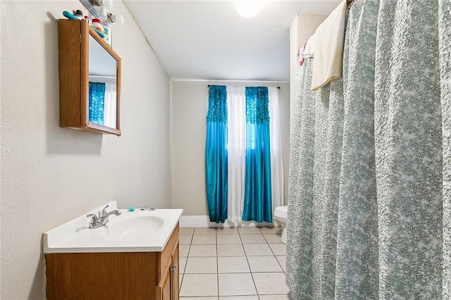 bathroom with tile patterned floors, curtained shower, vanity, and toilet