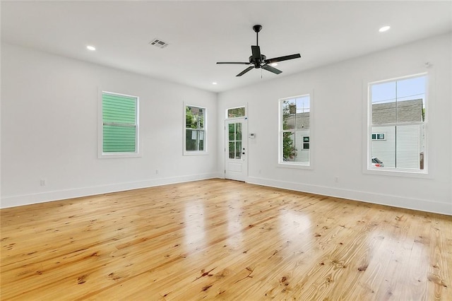 empty room with light hardwood / wood-style flooring and ceiling fan