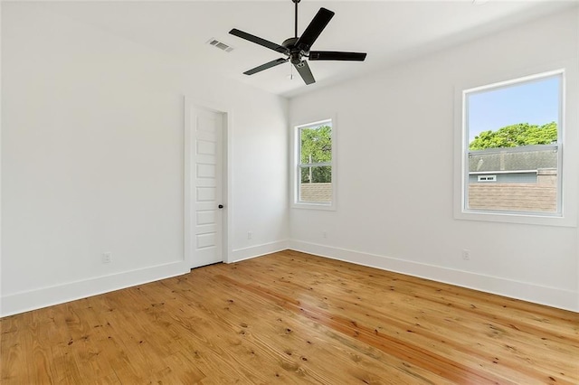 spare room featuring light hardwood / wood-style flooring and ceiling fan