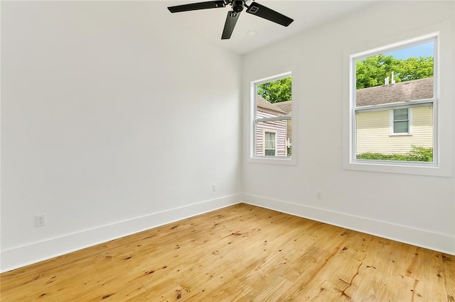 empty room featuring ceiling fan and light hardwood / wood-style flooring