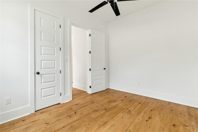 spare room with light wood-type flooring and ceiling fan