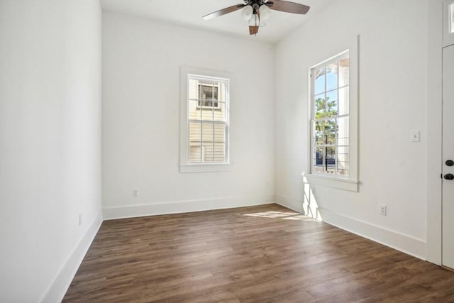 spare room featuring dark wood-type flooring and ceiling fan