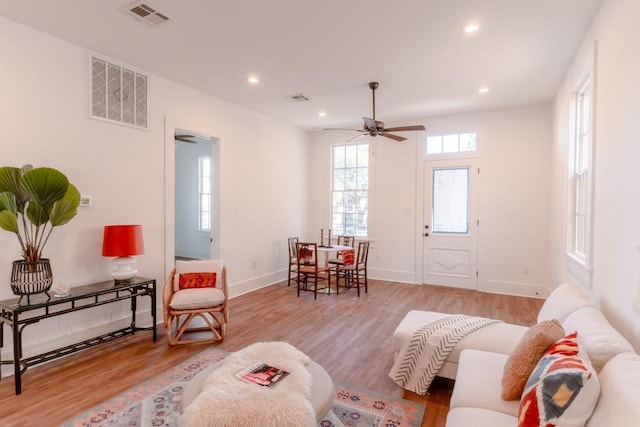 living room featuring ceiling fan and light hardwood / wood-style floors