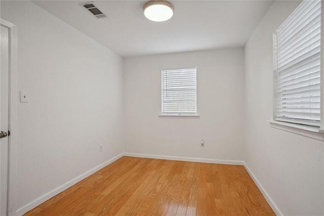 unfurnished room with wood-type flooring