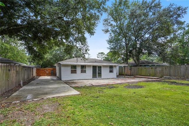 back of property featuring a patio area and a yard