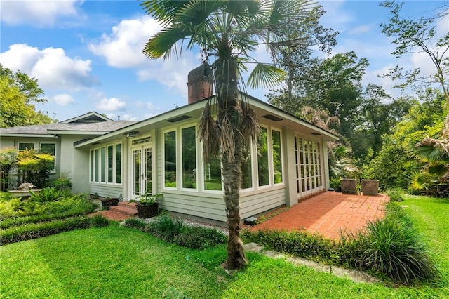 view of side of home featuring a lawn