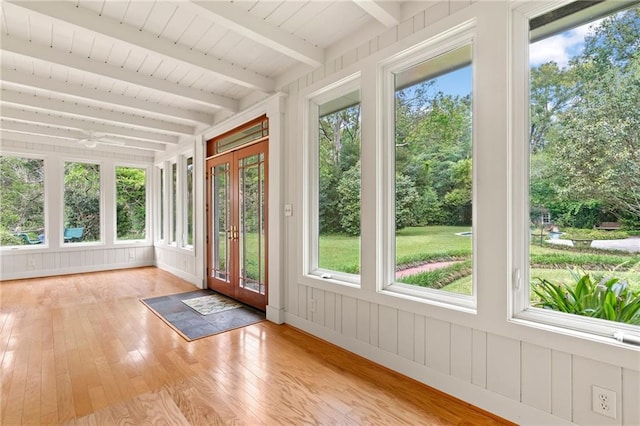 unfurnished sunroom with beam ceiling