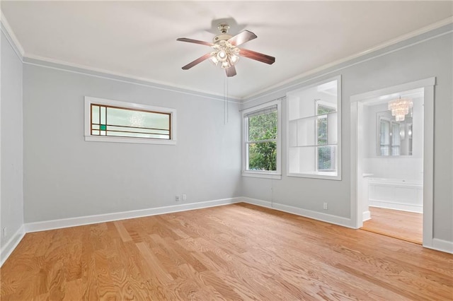 empty room with ornamental molding, light hardwood / wood-style flooring, and ceiling fan