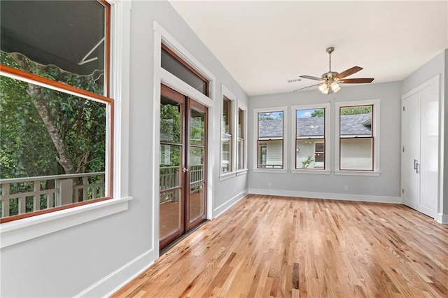 unfurnished sunroom featuring a wealth of natural light and ceiling fan