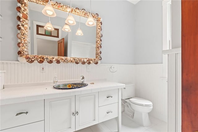 bathroom featuring tile patterned floors, vanity, and toilet