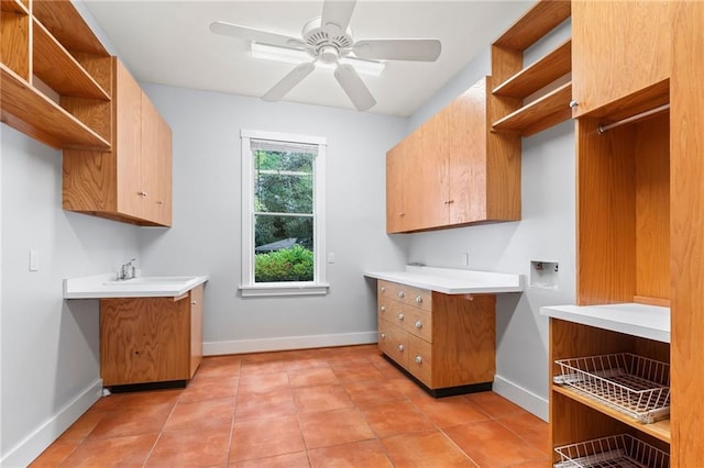 laundry area featuring sink, ceiling fan, hookup for a washing machine, and light tile patterned floors