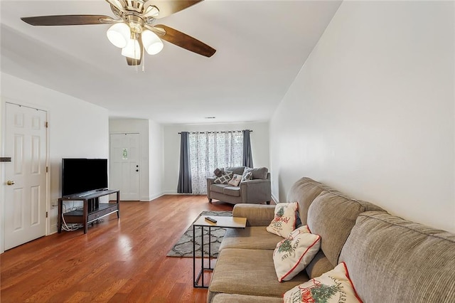 living room with wood-type flooring and ceiling fan