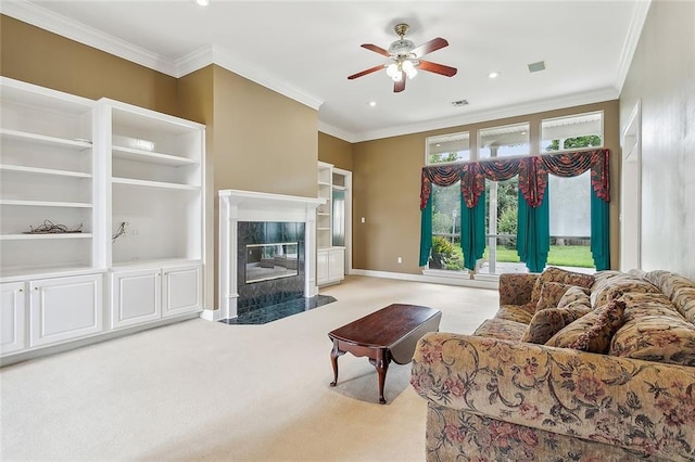 carpeted living room featuring a premium fireplace, ceiling fan, and crown molding