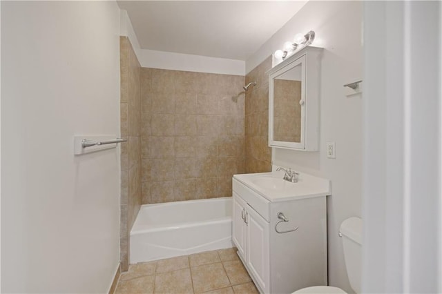 full bathroom featuring tile patterned flooring, toilet, vanity, and tiled shower / bath