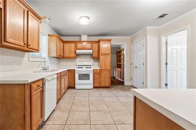 kitchen with light tile patterned flooring, white appliances, a textured ceiling, sink, and ornamental molding