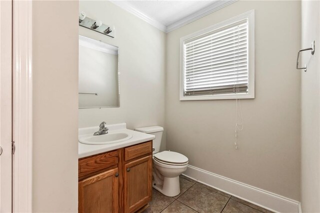 bathroom featuring vanity, ornamental molding, toilet, and tile patterned flooring