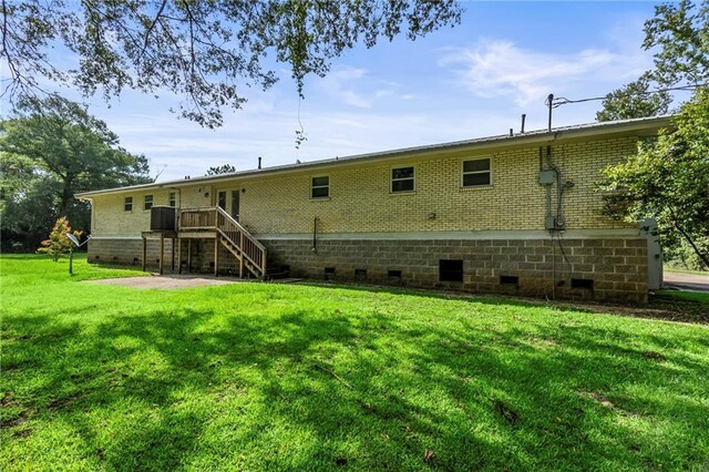 rear view of property featuring a yard