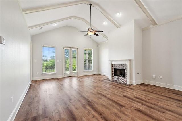 unfurnished living room featuring hardwood / wood-style flooring, ceiling fan, a high end fireplace, and high vaulted ceiling