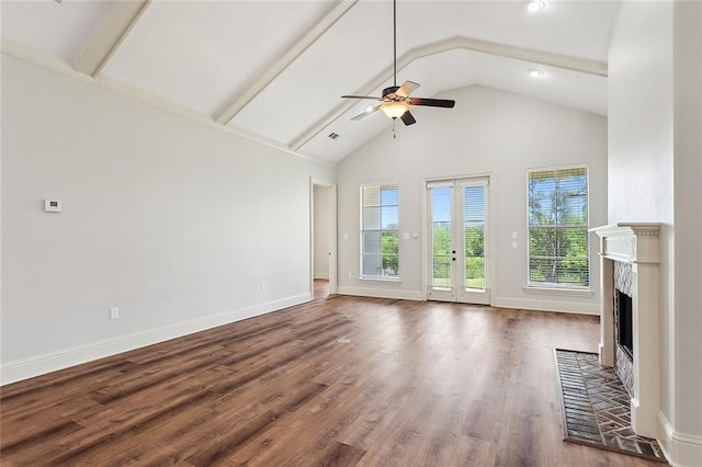 unfurnished living room featuring a tile fireplace, high vaulted ceiling, beamed ceiling, ceiling fan, and dark wood-type flooring