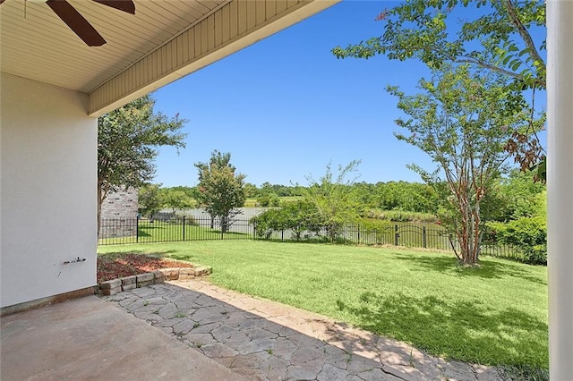 view of yard featuring ceiling fan and a patio