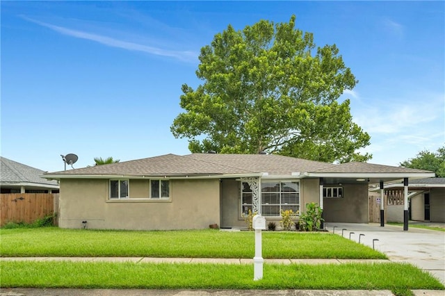 ranch-style home with a front lawn and a carport