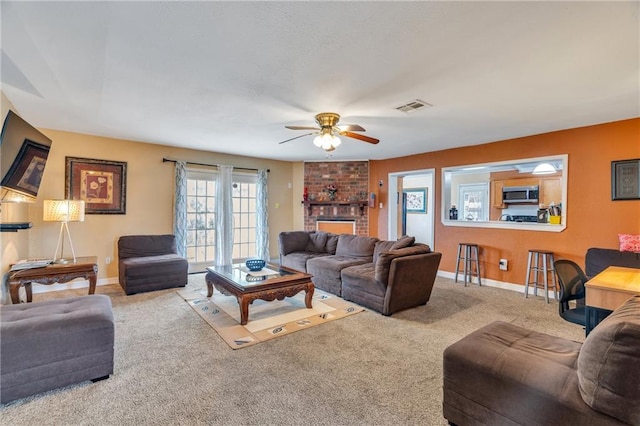 living room featuring ceiling fan, carpet, and a fireplace