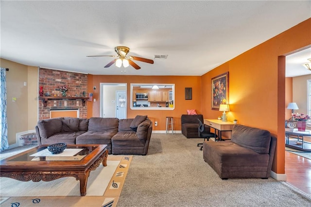 carpeted living room featuring ceiling fan