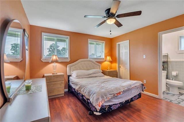 bedroom featuring dark wood-type flooring, ceiling fan, and connected bathroom