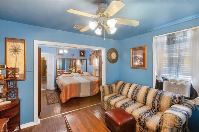 bedroom with ceiling fan, cooling unit, and dark hardwood / wood-style flooring