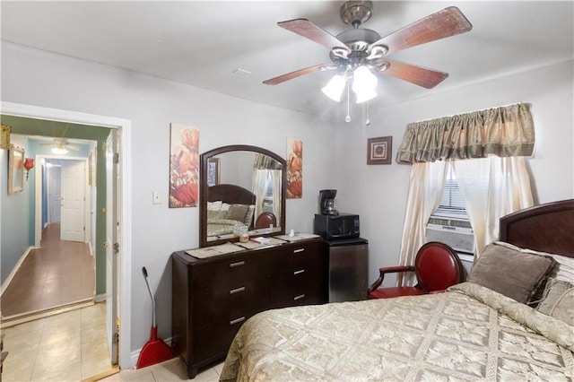 tiled bedroom with ceiling fan and cooling unit