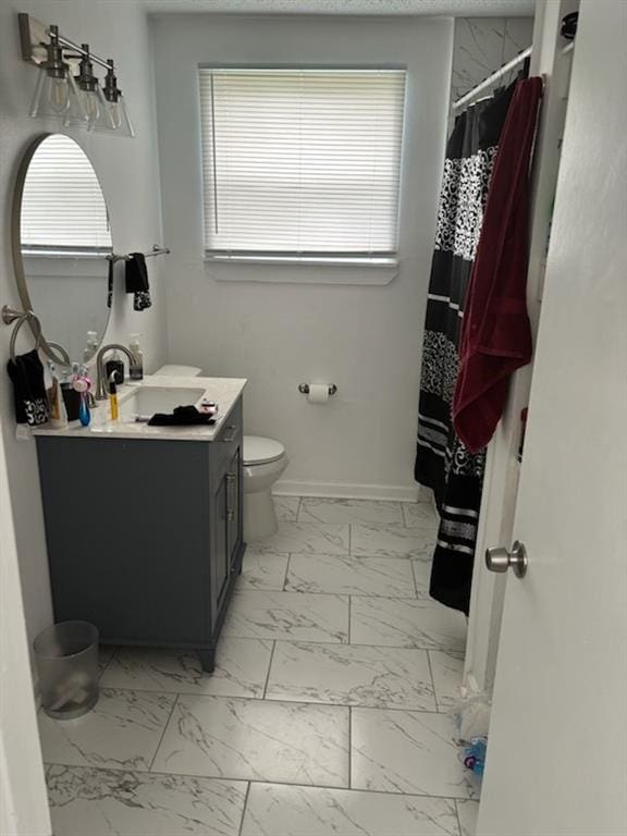 bathroom with vanity, tile patterned floors, and toilet