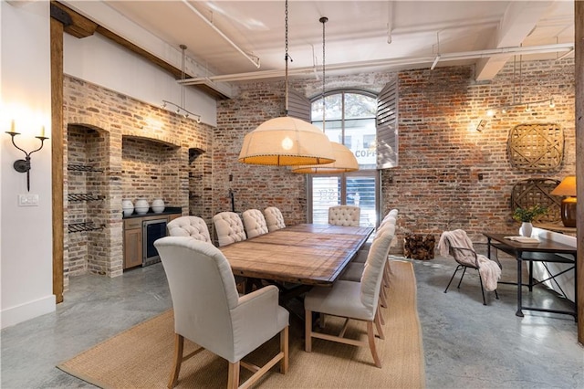 dining space featuring brick wall