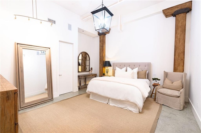 bedroom with a notable chandelier