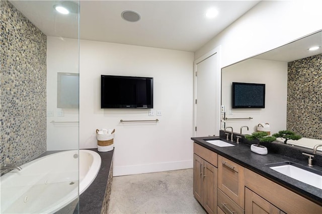 bathroom featuring tiled bath, vanity, and concrete flooring