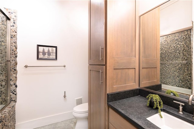 bathroom featuring walk in shower, tile patterned flooring, vanity, and toilet